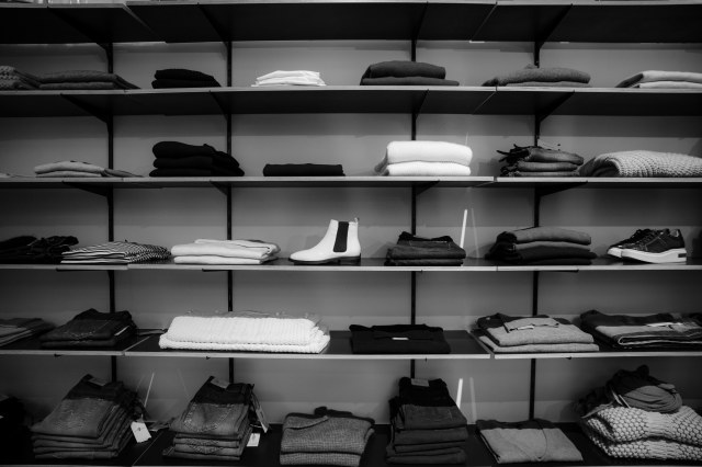 Grey scale image of clothing store shelves